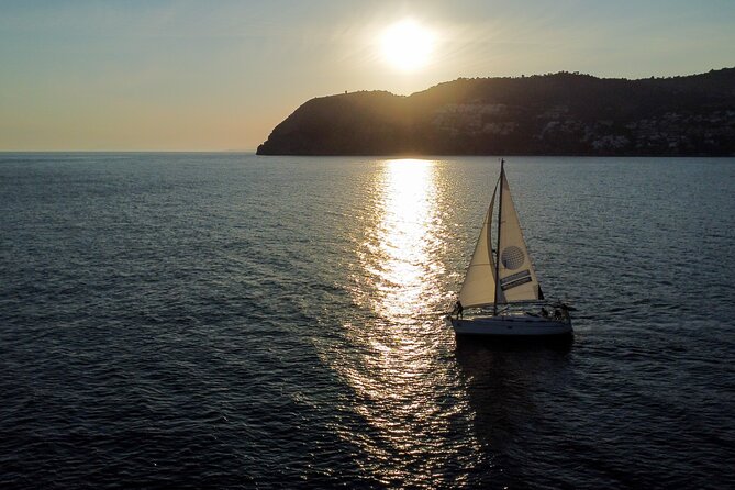 Sailing at sunset along the cliffs of Maro-Compartida - The Toast, the Welcome Catering, and the Romantic Rhythm